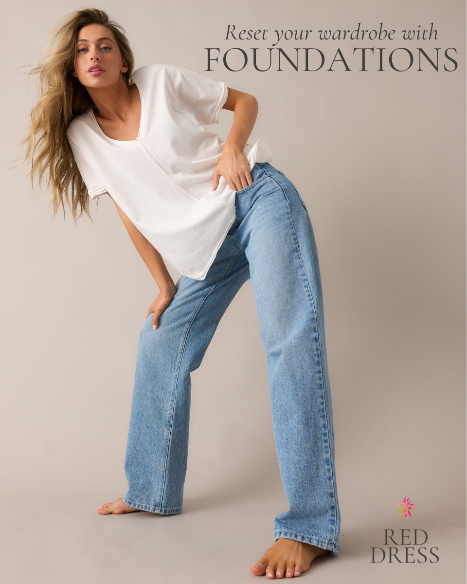 Model wearing wide leg, straight, medium wash jeans with a loose fitting white tee shirt.