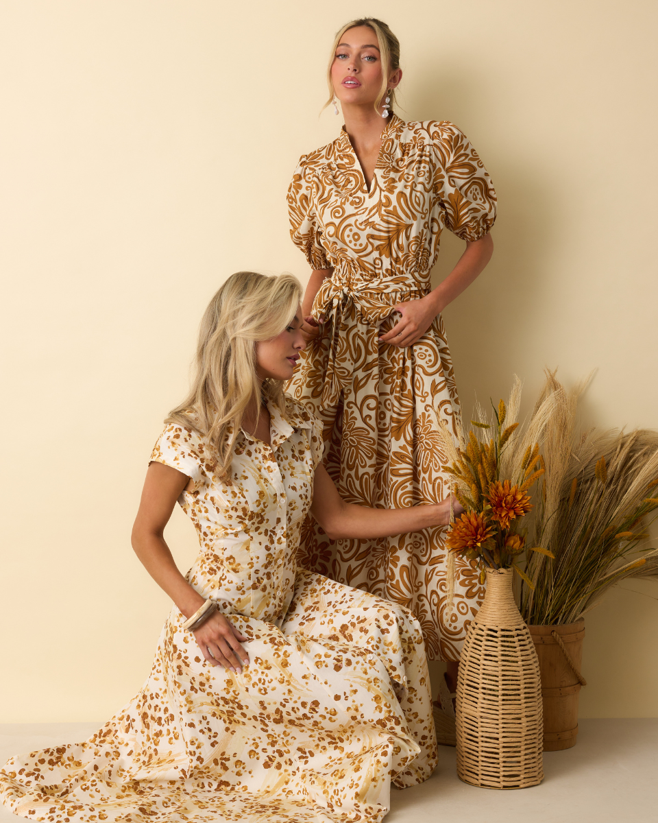 Image of models wearing different golden yellow multi print maxi dresses.