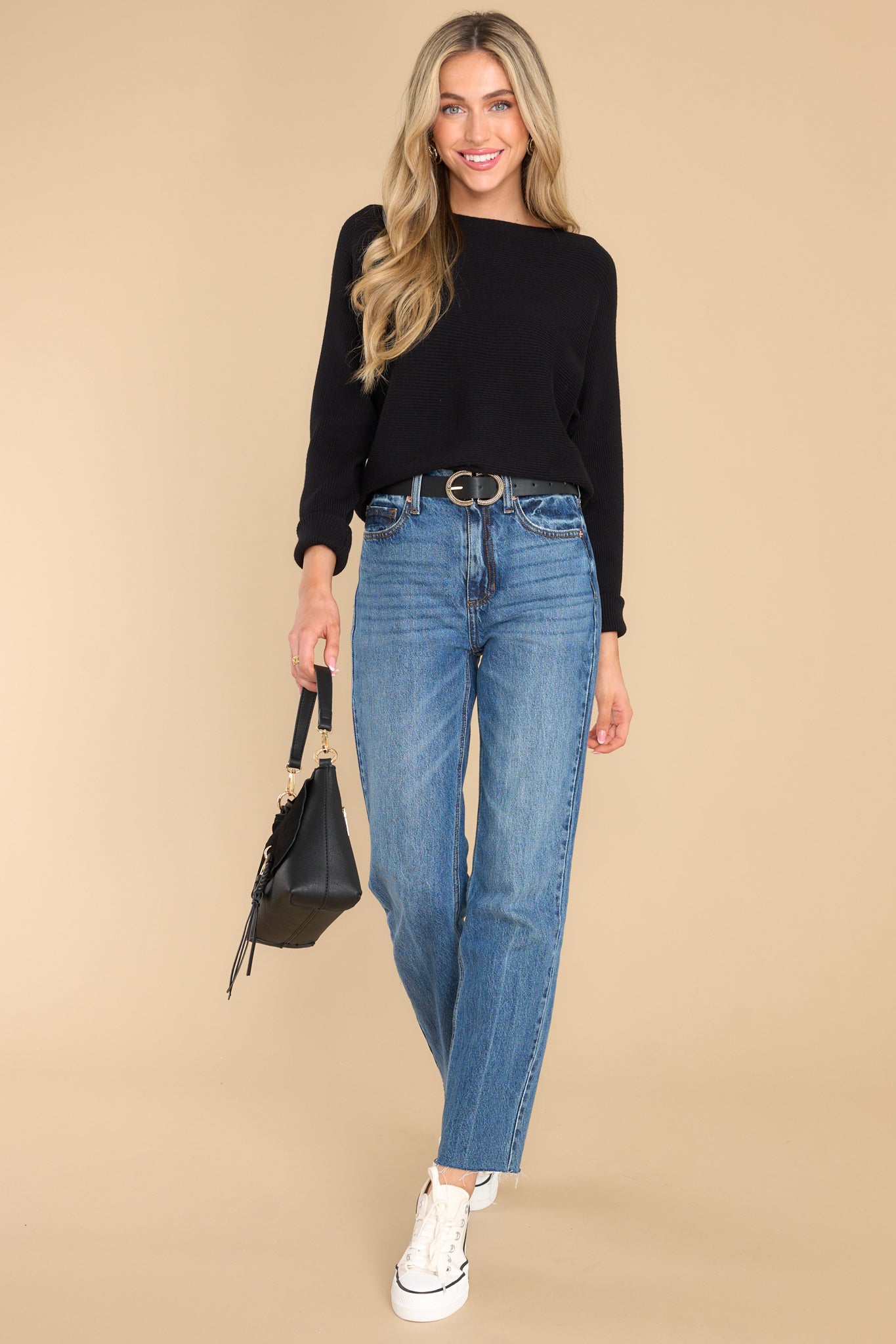 Full body view of this sweater that features a round neckline and a soft stretchy material.