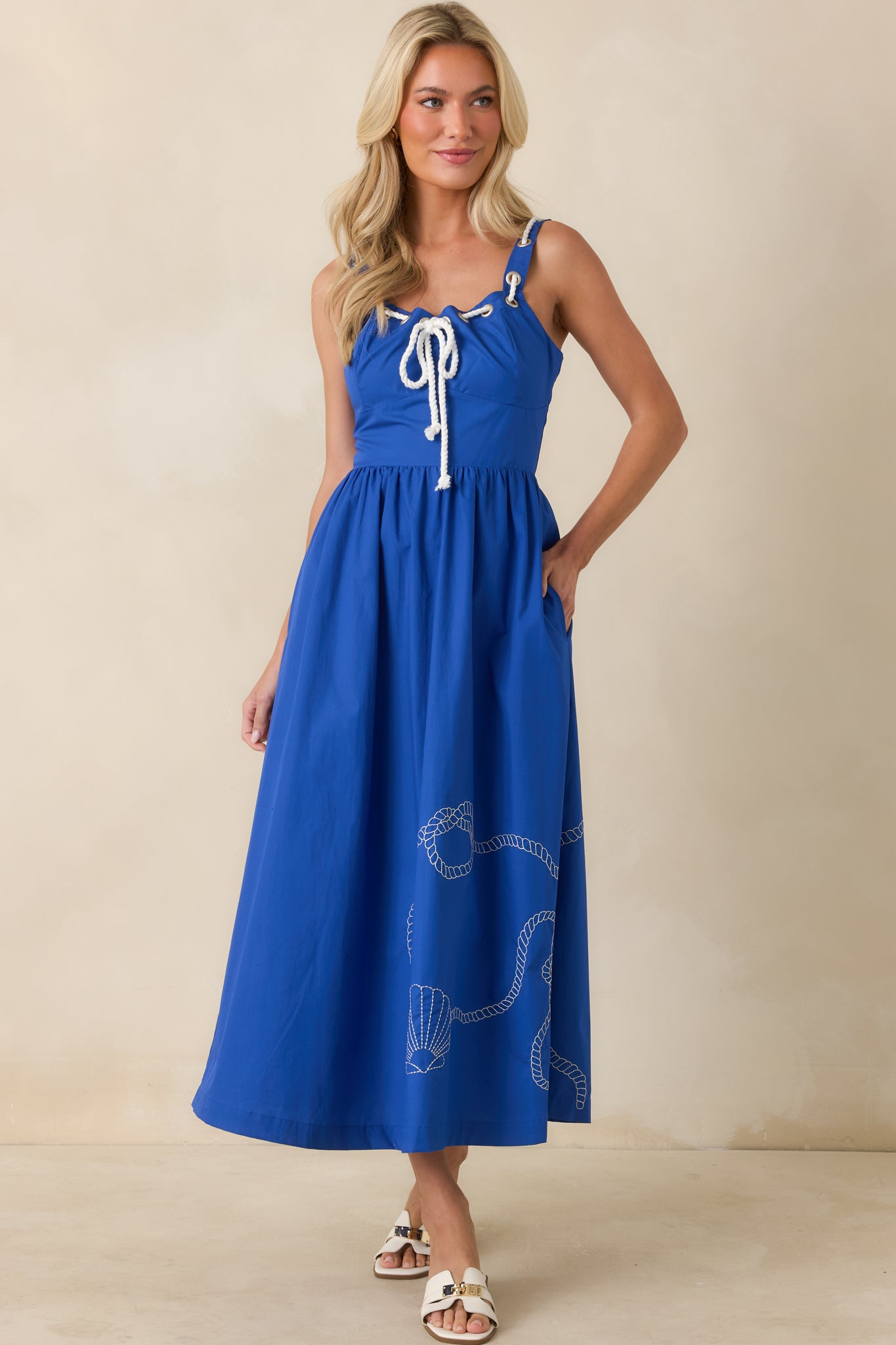 Royal blue midi dress showcasing a lace-up front neckline, wide straps, and a relaxed flowing fit.