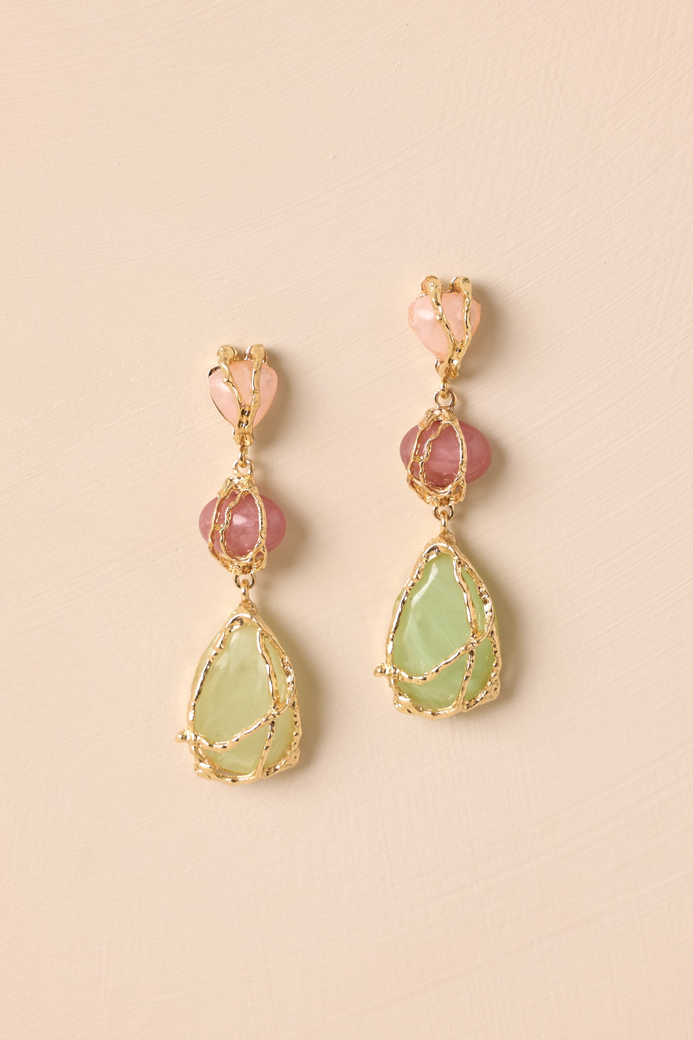 Close-up of drop dangle structure and textured gold wrapping around the colorful stones.
