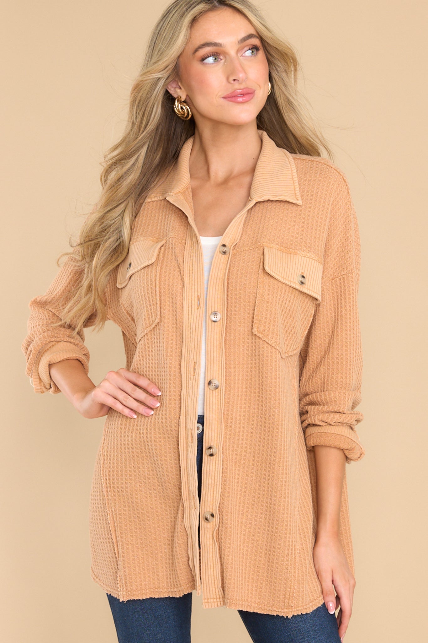 Front view of this top that features a collared neckline, functional buttons down the front, bust pockets with button closures, and long sleeves with buttoned cuffs.