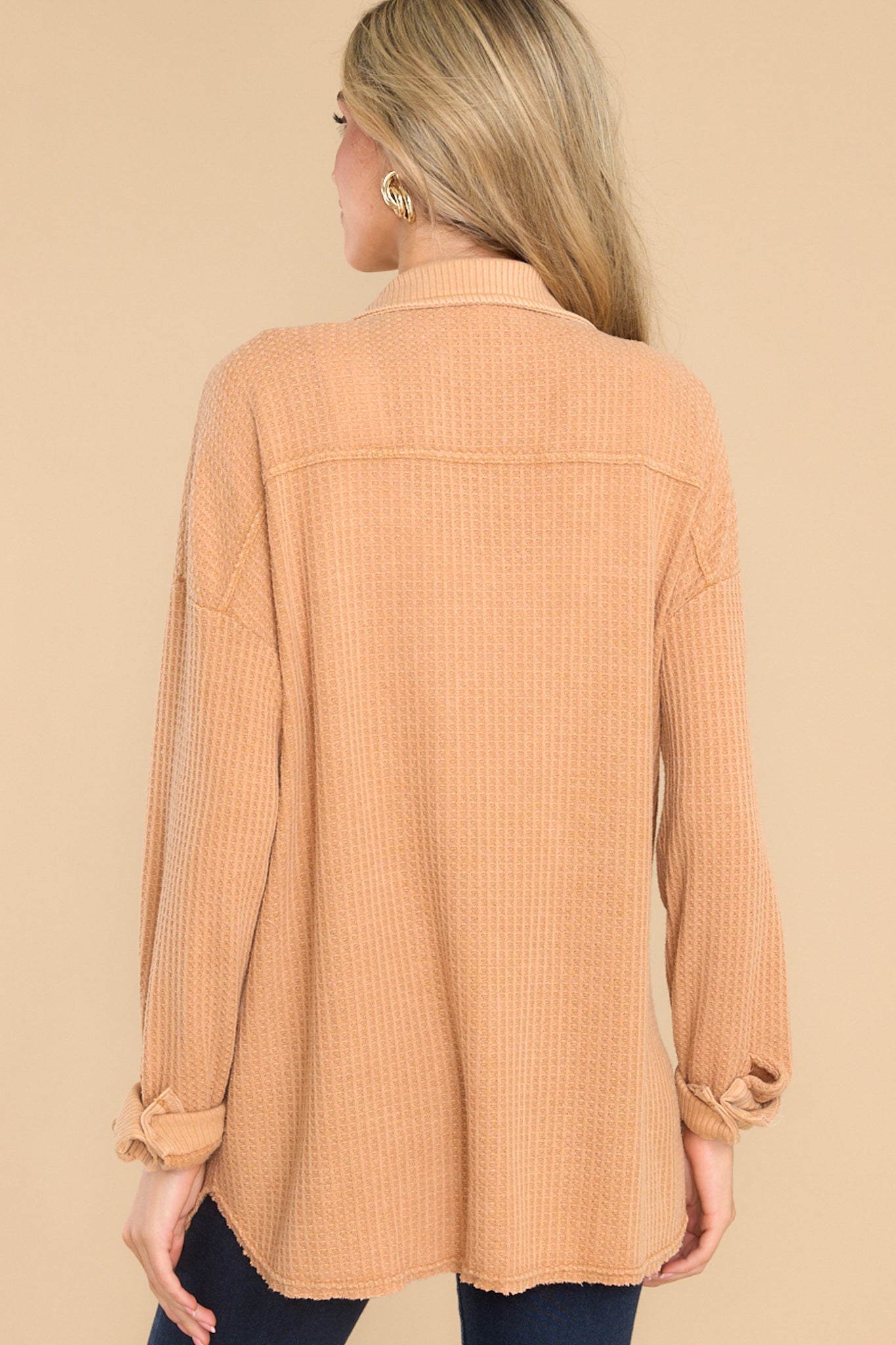 Back view of this top that features a collared neckline, functional buttons down the front, bust pockets with button closures, long sleeves with buttoned cuffs, and a mixed-textured design throughout.