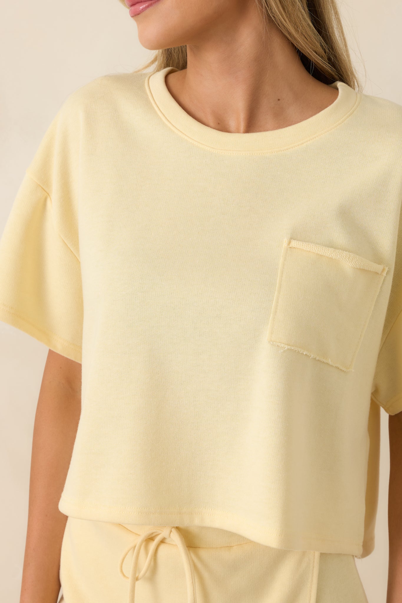Cropped top detail showing the relaxed fit and lightweight sweatshirt-inspired fabric blend.
