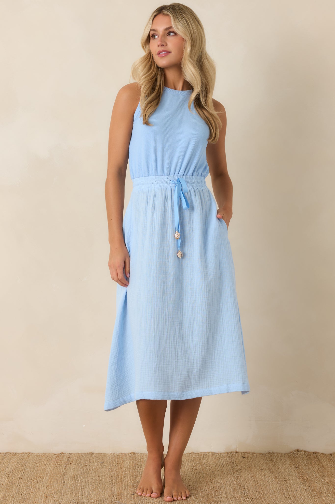 Textured cotton midi dress with an easy silhouette, gathered elastic waist, and fluid skirt movement.