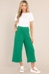 Full front view of  these pants that feature a high waisted design, an elastic waistband, functional hip pockets, a textured crisscross design, and a wide leg.