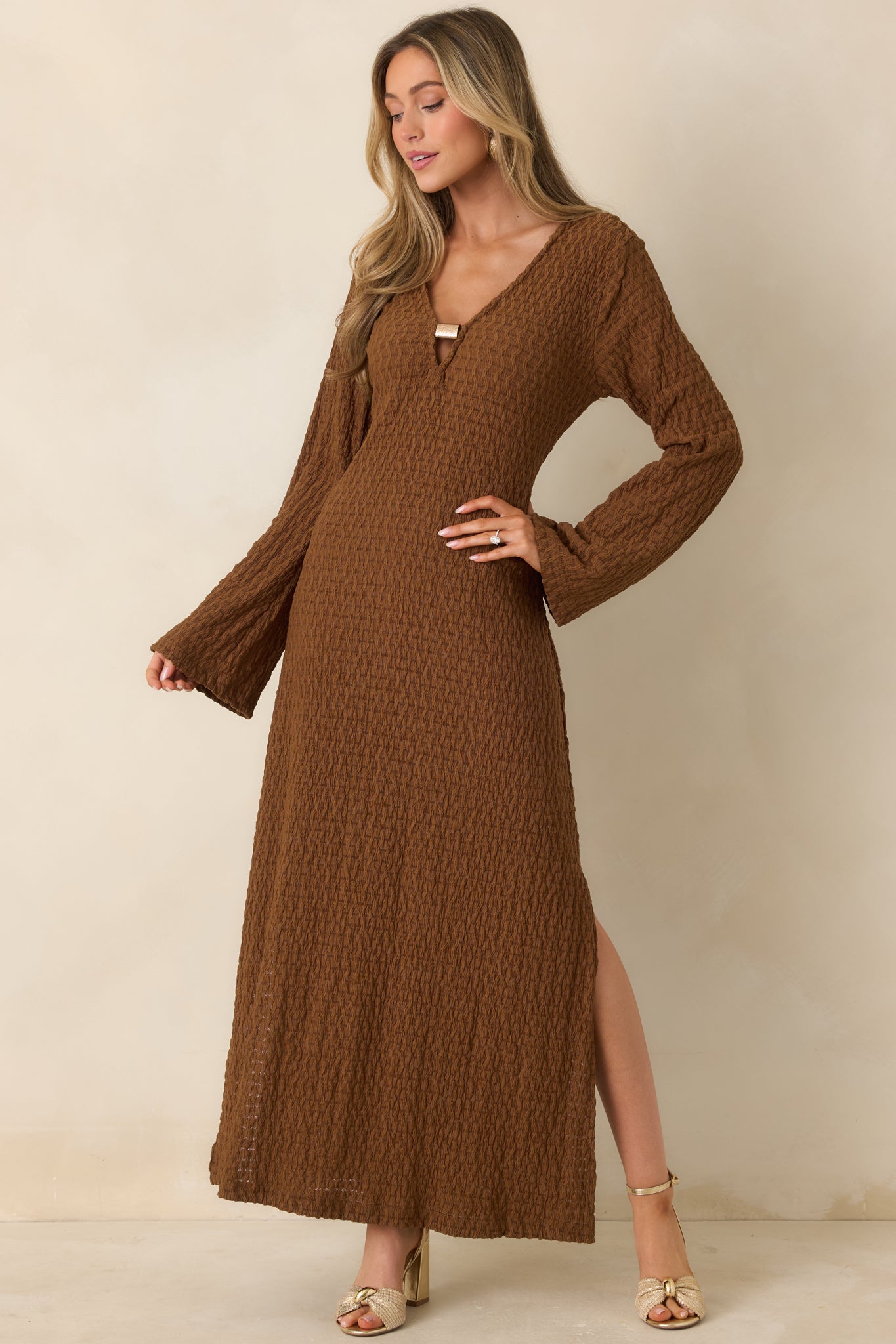Full-length front shot of a lightweight brown maxi dress featuring subtle texture and elegant drape.