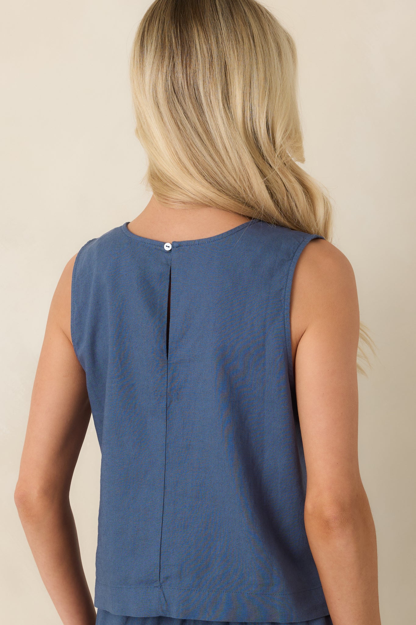 Rear view of linen blend top featuring relaxed boxy fit and subtle keyhole detail.