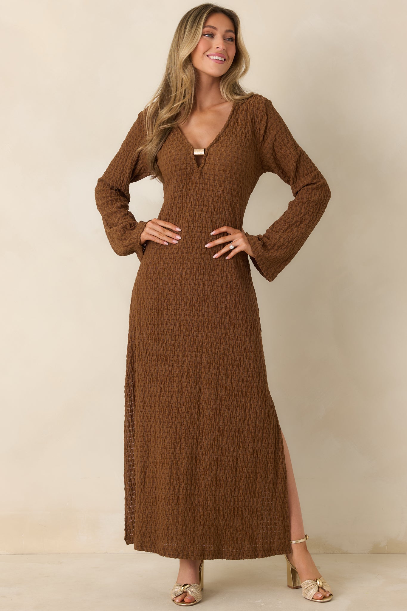 Front-facing view highlighting the flowing skirt and textured fabric of a brown maxi dress.