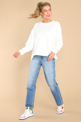 Full body view of this sweater that features a scoop neckline and two slits at sides.