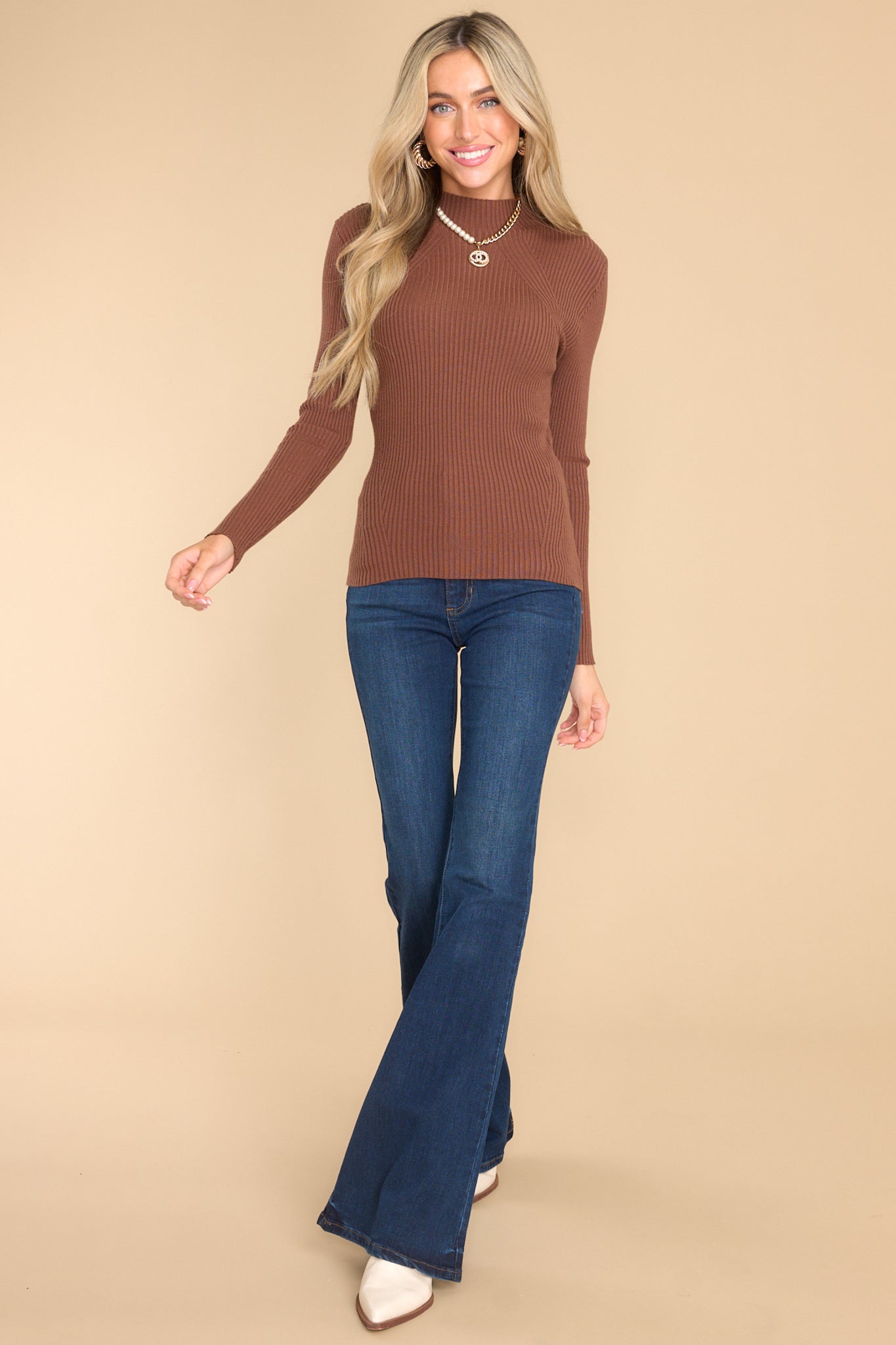 Full body view of fitted long sleeve top with ribbed detailing.