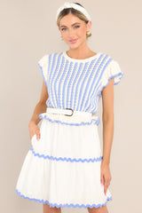 Front view of this dress that features a scalloped crew neckline, a striped knitted bodice, a ruffled waistline, functional pockets, scalloped detailing, a scalloped hemline, and ruffled sleeves.