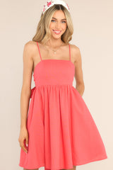 Front view of this dress that features a square neckline, skinny adjustable shoulder straps, and a flowy short skirt.