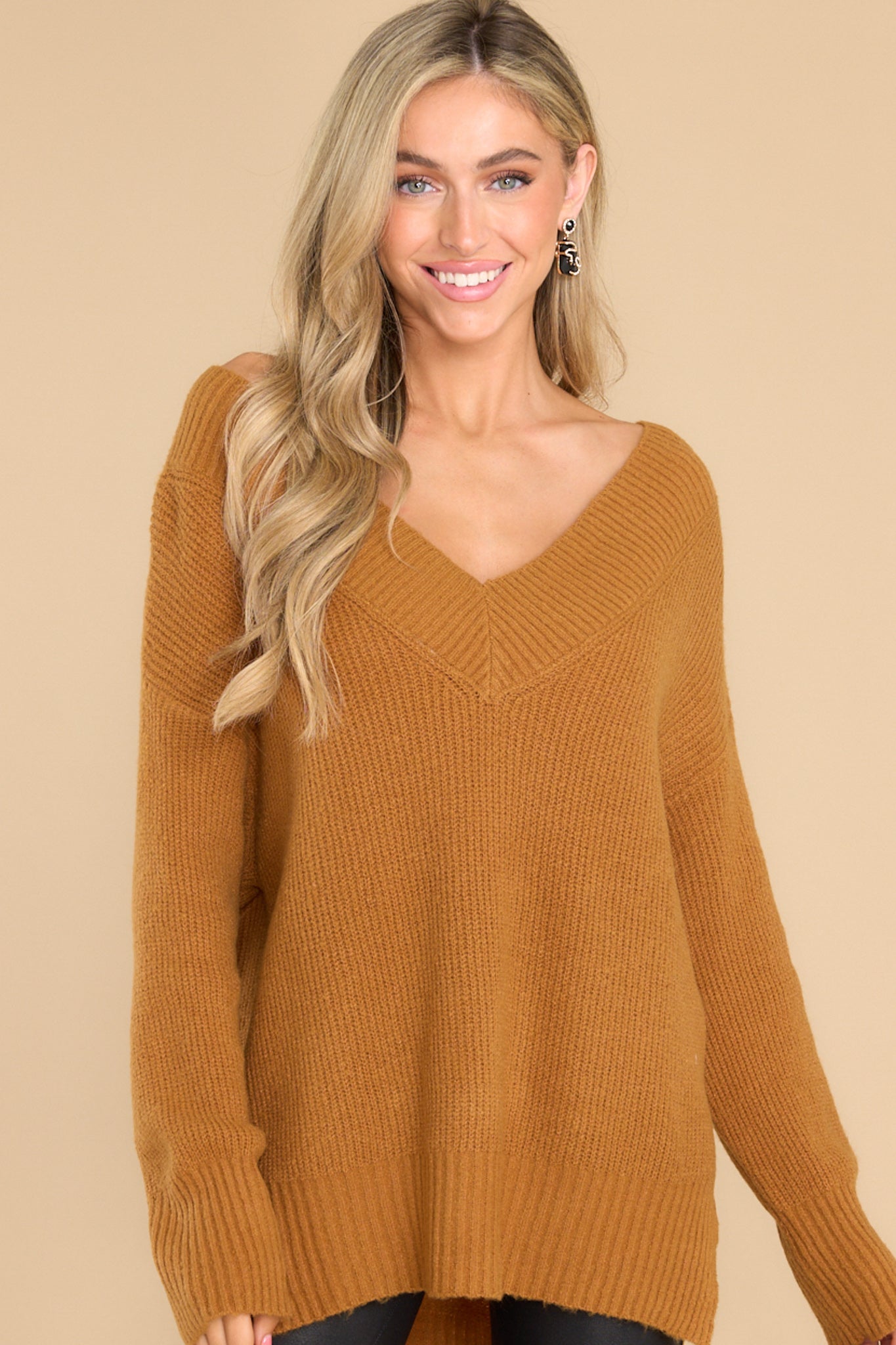 Front view of this sweater that features a wide v-neckline and long sleeves with ribbed cuffs.