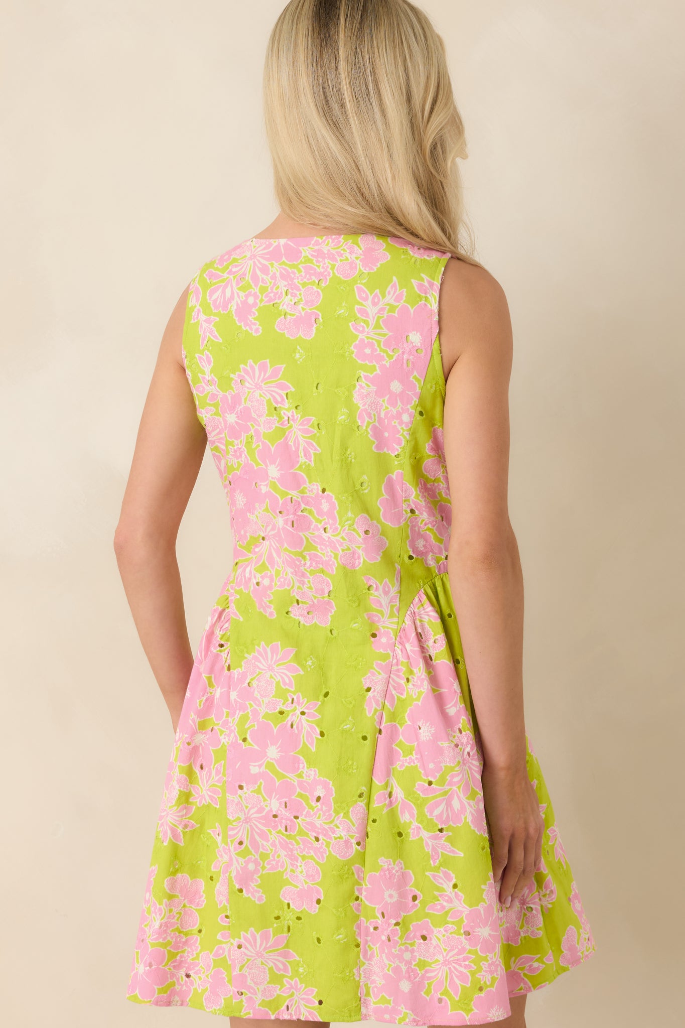 Rear view of cotton mini dress with clean structure and softly flared skirt.