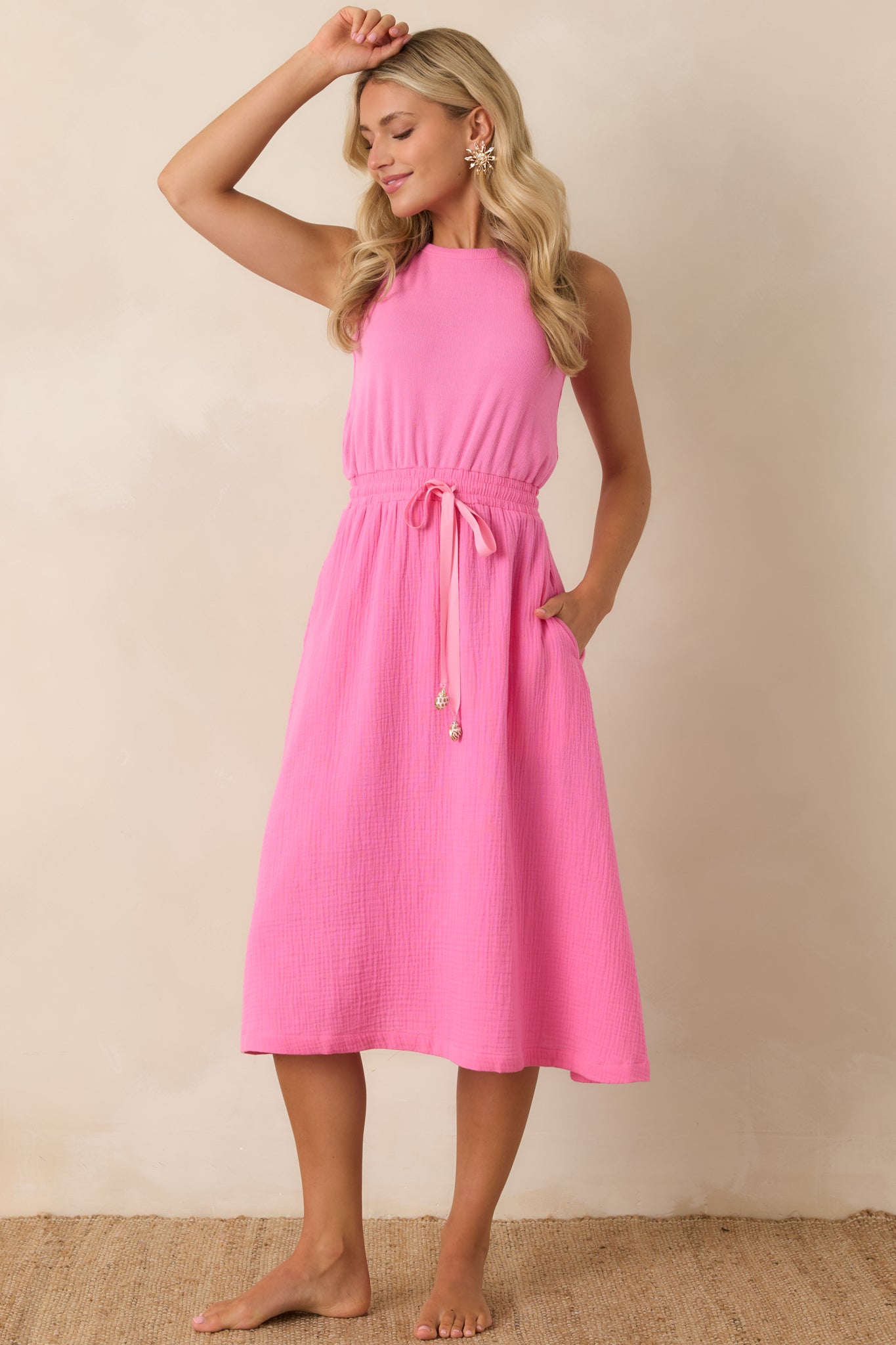 Sleeveless midi dress with a drawstring waist detail and fluid skirt for comfortable movement.