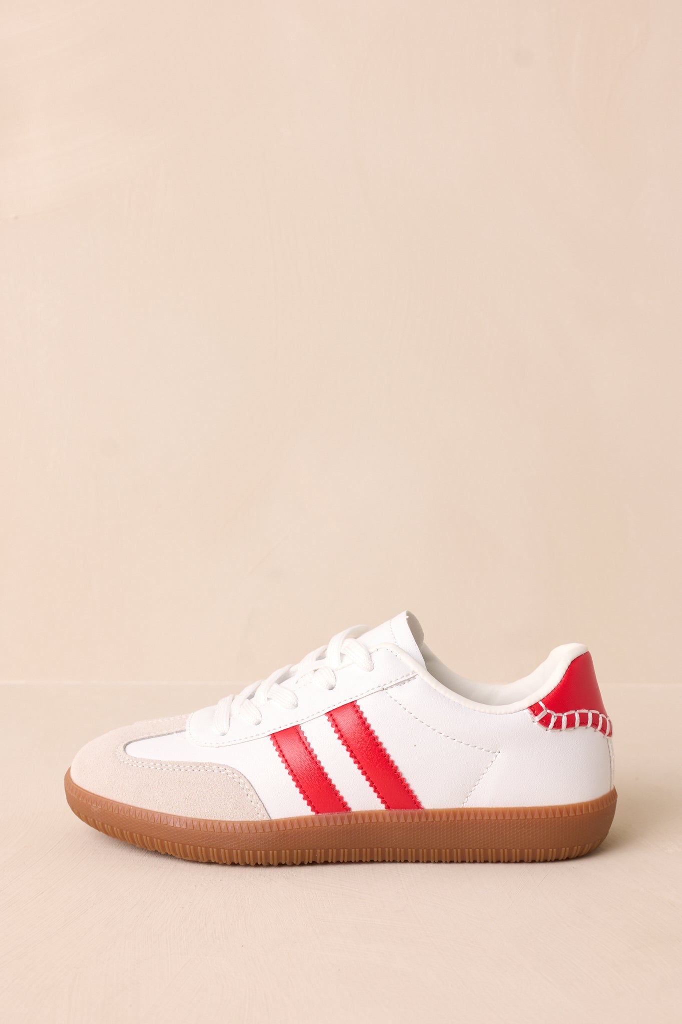 A slightly different side perspective showcasing the ricrac stripes, brown sole, and smooth faux leather texture.