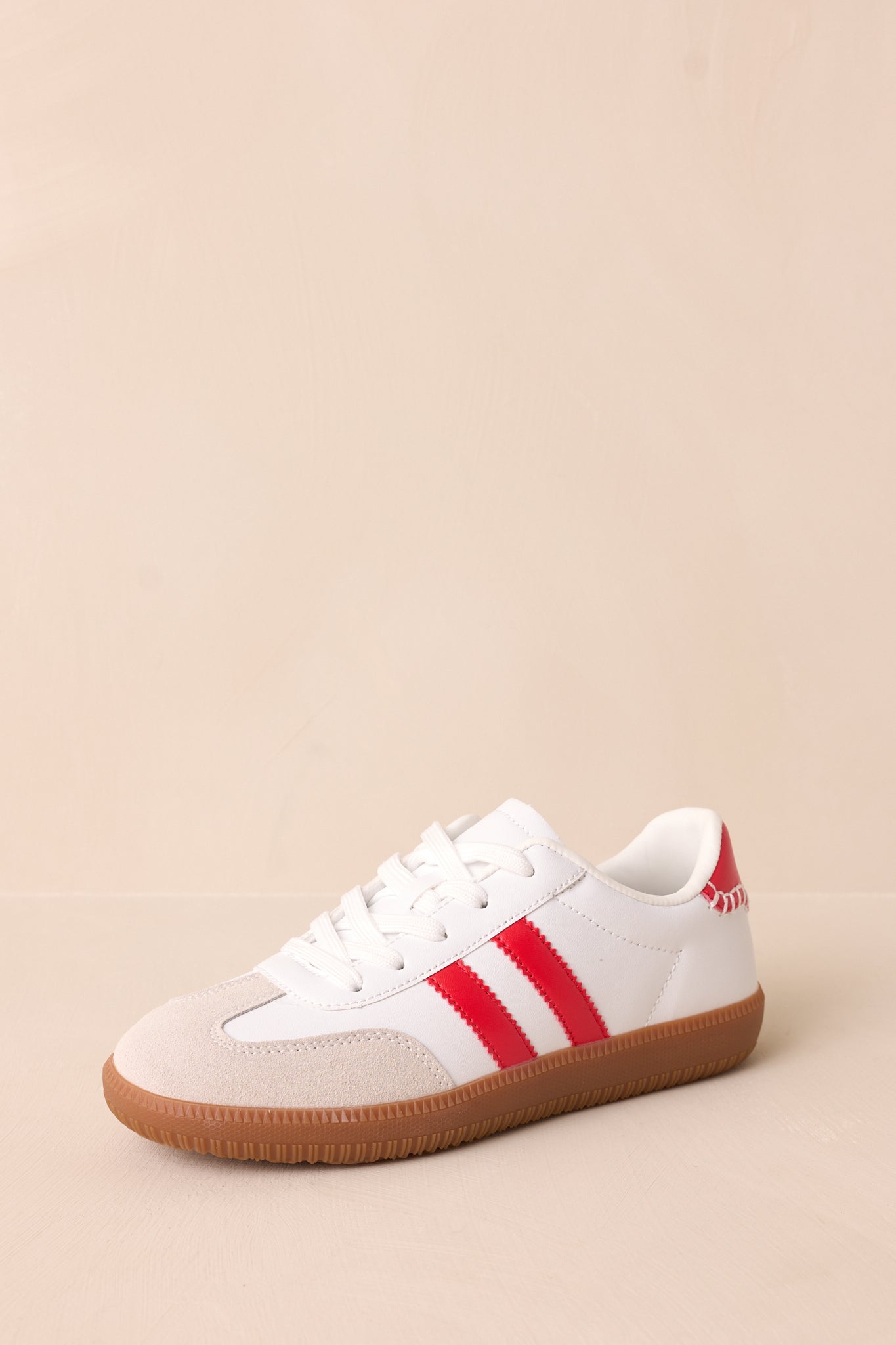 A close-up of the red faux leather ricrac stripes, emphasizing their wavy design and contrast against the white background.