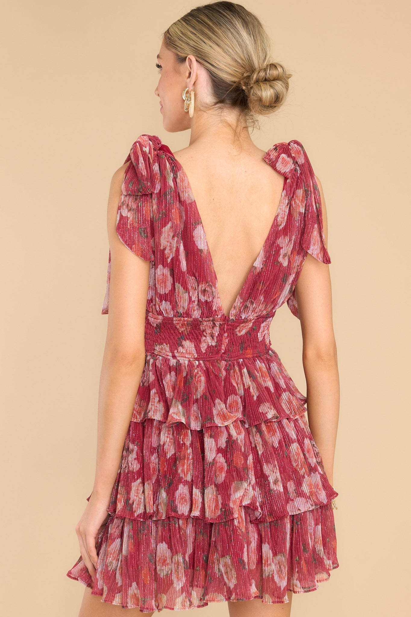 Back view of floral mini dress with a functional back zipper closure.