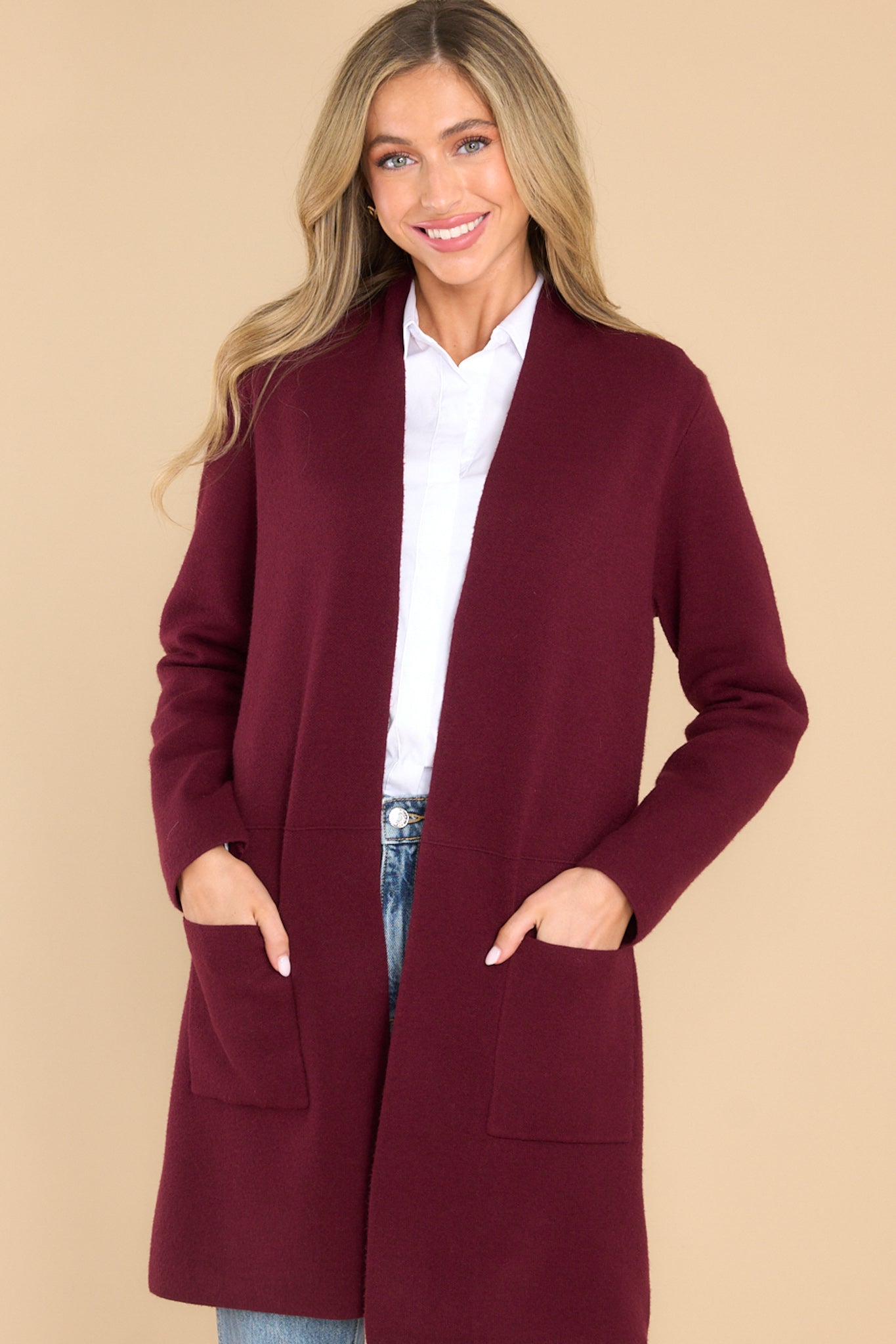 Front view of this cardigan that features an open front design, two functional pockets, long sleeves, and a soft knit feel throughout.
