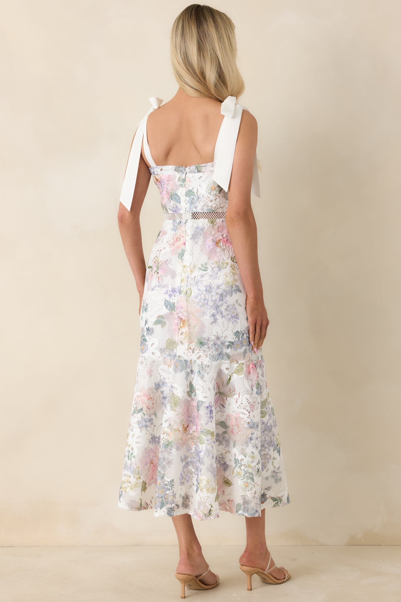 Back view of the midi dress featuring a hidden zipper and lace knit fabric extending across the single-tier silhouette.