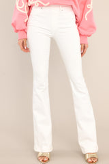These white jeans feature flared legs, belt loops, and an elastic waistband.