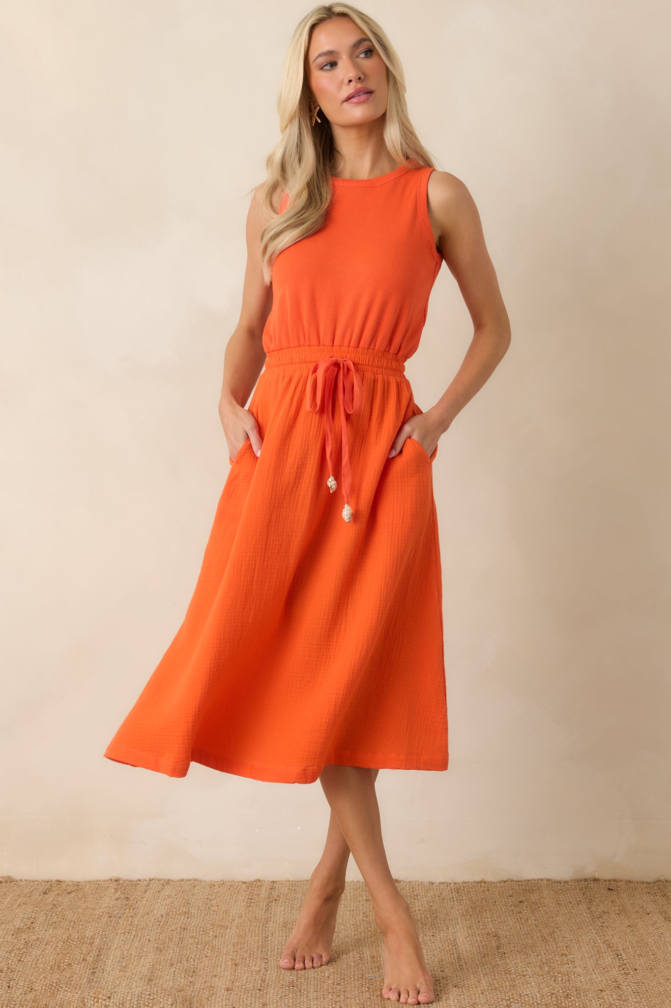 Relaxed midi dress with a round neckline, cinched waist detail, and effortless drape.