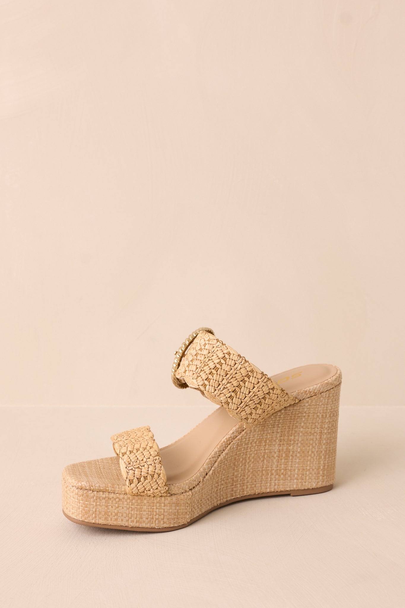 A slightly tilted side angle highlighting the wedged heel and how it complements the double-strap design.