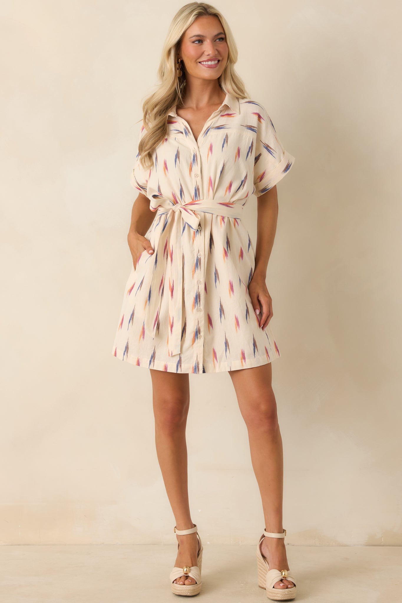 Button-front shirt dress featuring a relaxed fit, side pockets, and vibrant brushstroke-inspired multicolor detailing.