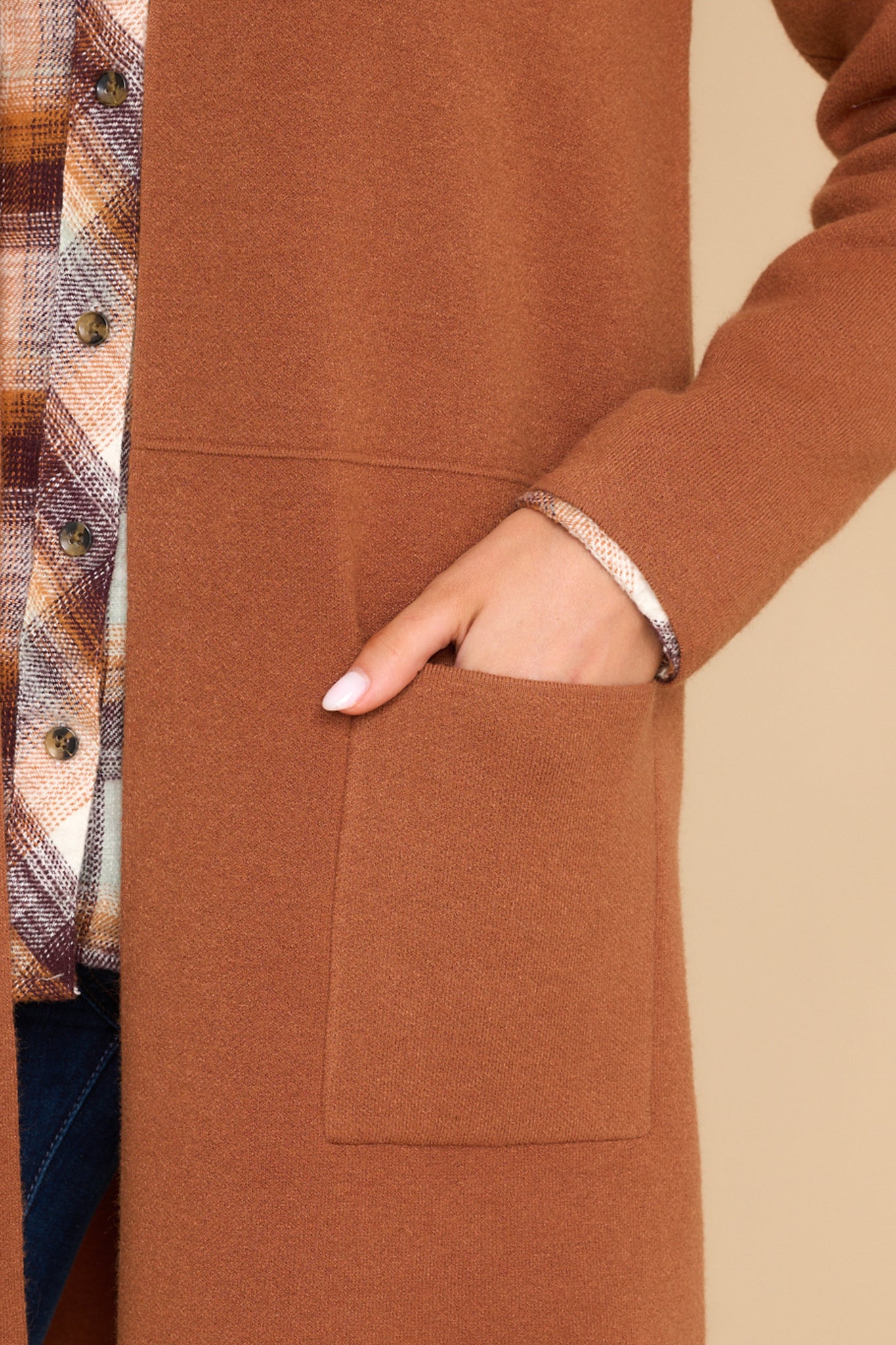 Close up view of this cardigan that features an open front design, two functional pockets, long sleeves, and a soft knit feel throughout.