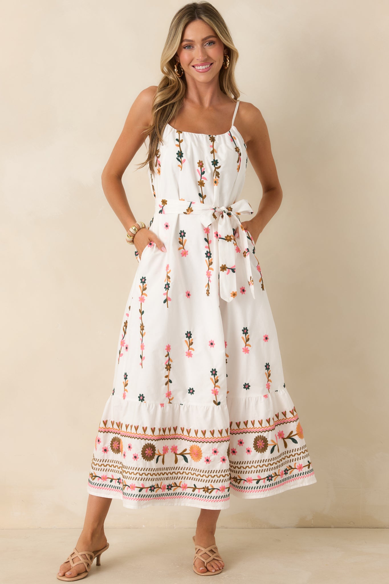 Ivory multi maxi dress showcasing side pockets and a lined, full-length drape.