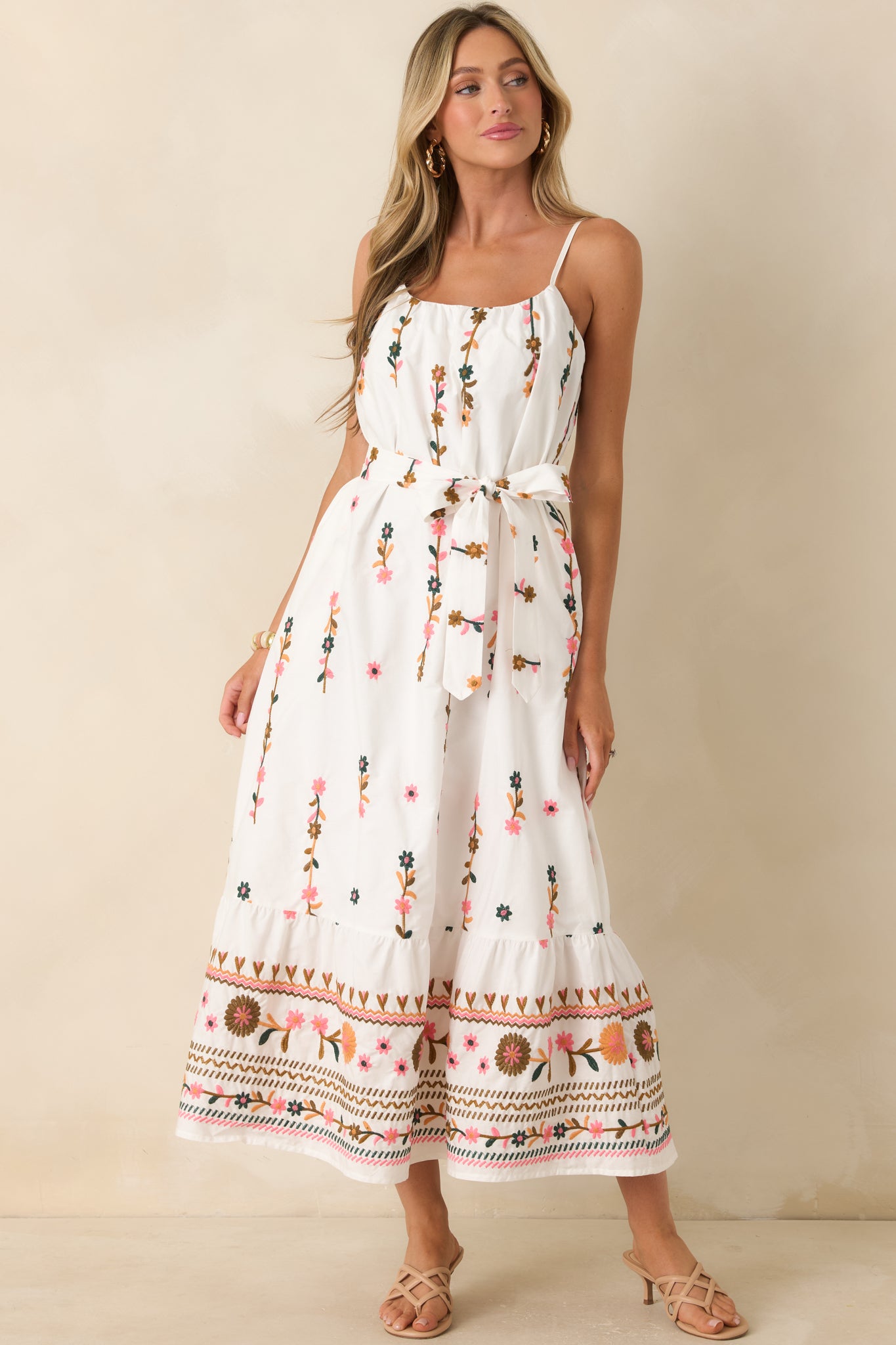 Ivory floral maxi dress featuring a softly gathered scoop neckline, adjustable spaghetti straps, and flowy silhouette.