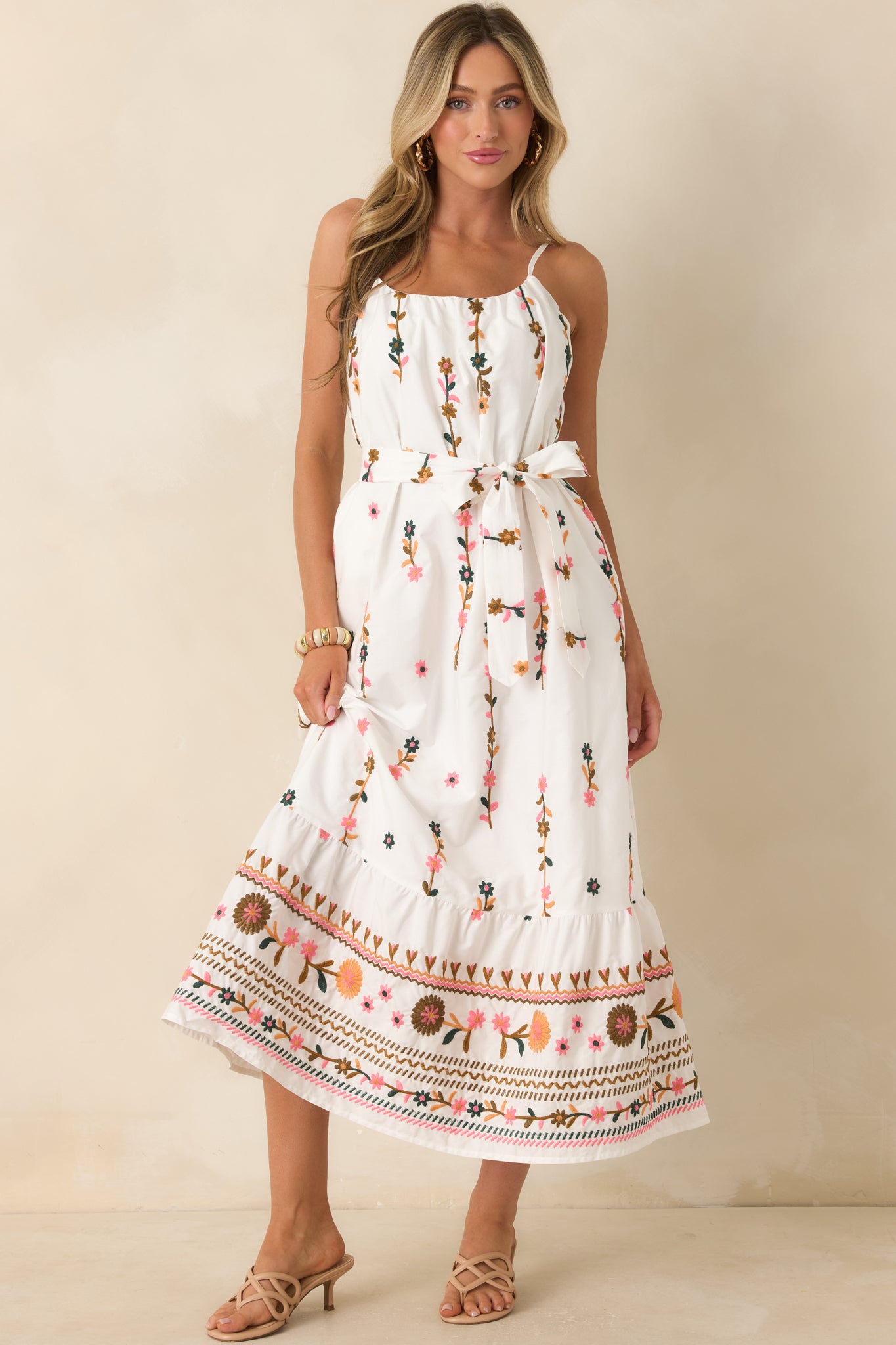 Flowing ivory floral dress highlighting intricate embroidery throughout and an easy warm-weather silhouette.