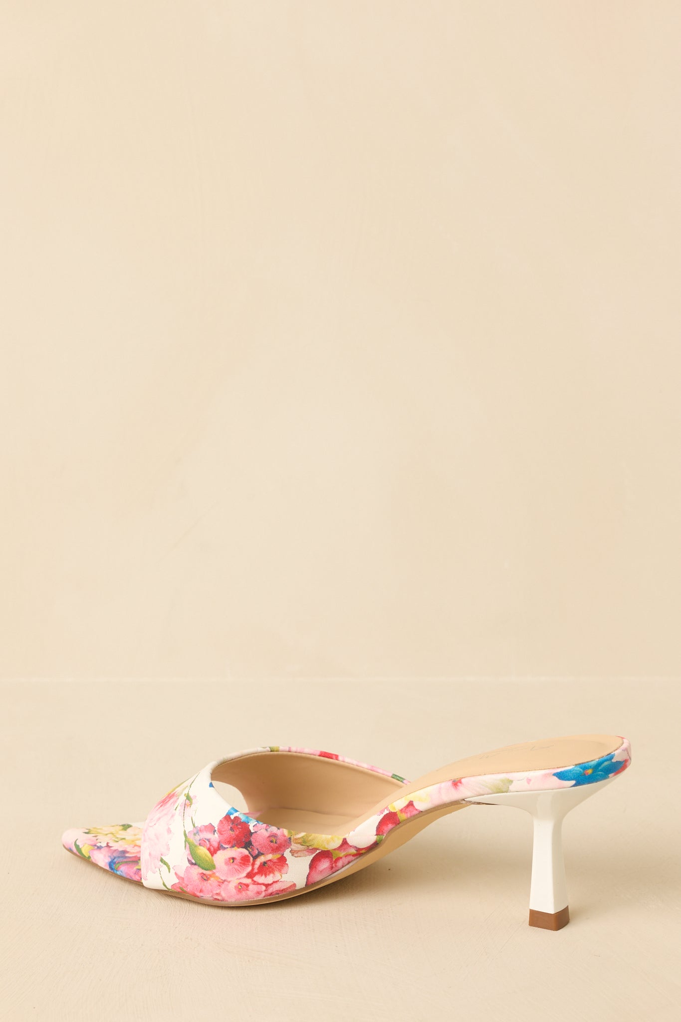 Back view of pink floral kitten heel mules showing open heel and slim kitten heel design.