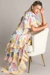 This multi-colored dress features a square neckline, butterfly sleeves, a fully smocked bust, and a long, flowy skirt.