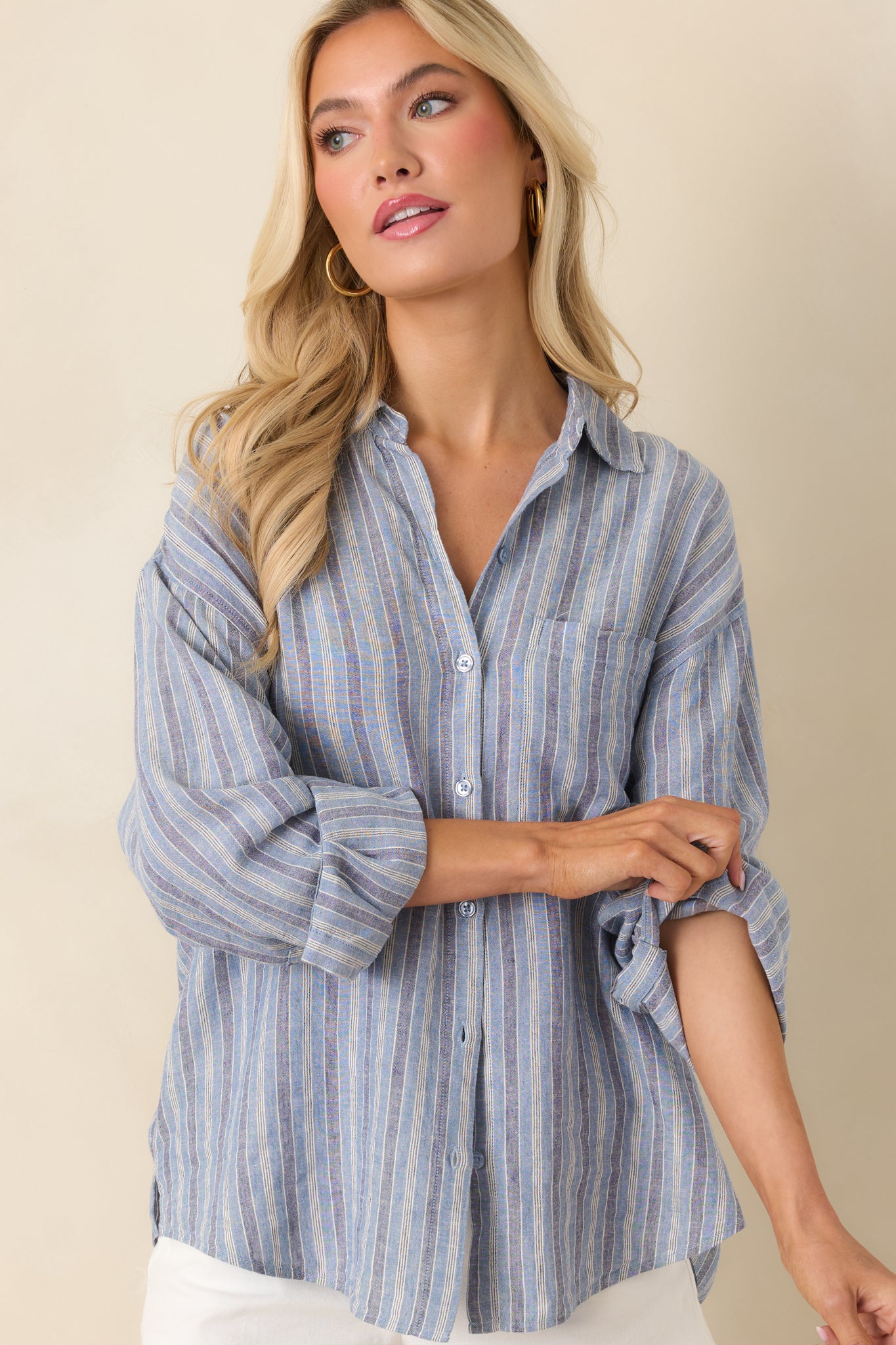 Button placket close view with indigo stripes and lightweight breathable fabric.
