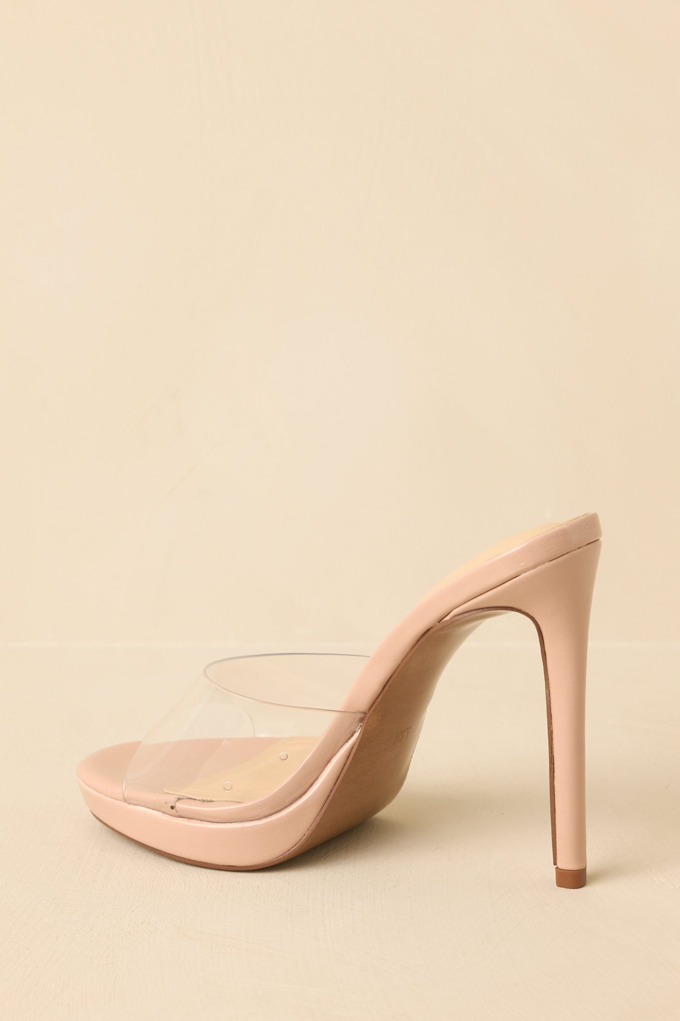 Beige clear stilettos angled to emphasize the polished stiletto heel and clean open-toe shape.