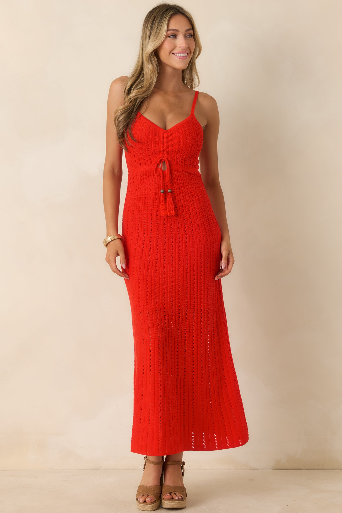 Fitted crochet maxi dress featuring thin adjustable straps, gathered front detailing, and a breezy warm-weather silhouette.