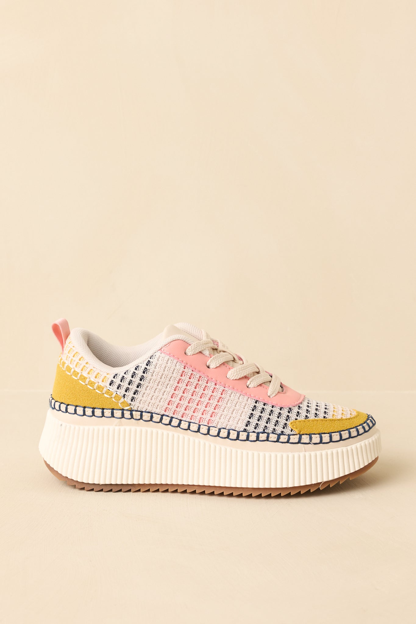 Pink multi platform sneakers emphasizing the rubber outsole and added height of the sole.