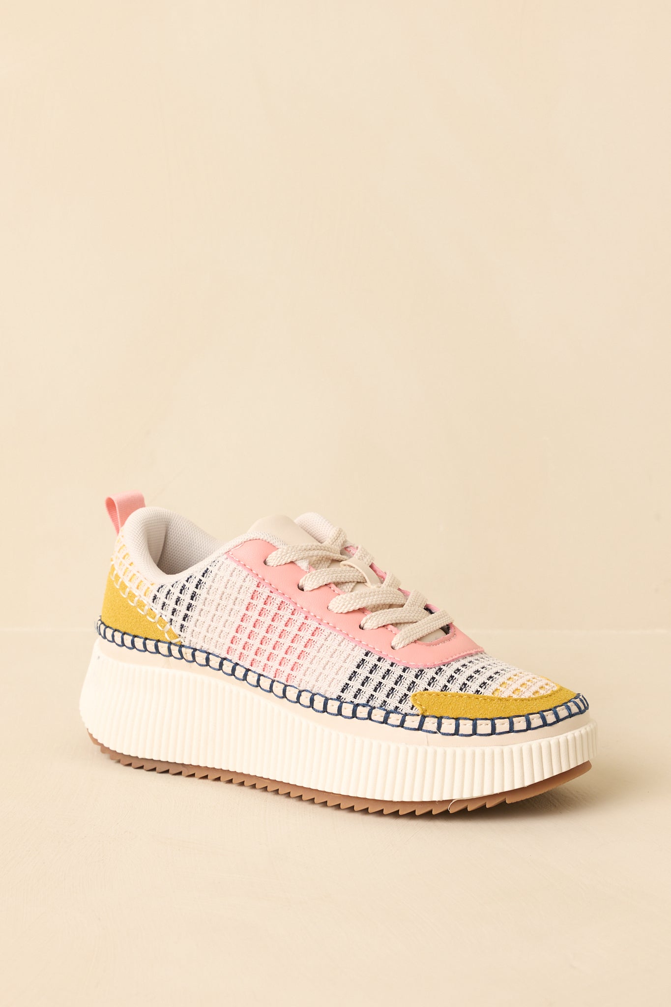 Pink multi sneakers angled to highlight the padded collar and breathable knit pattern.