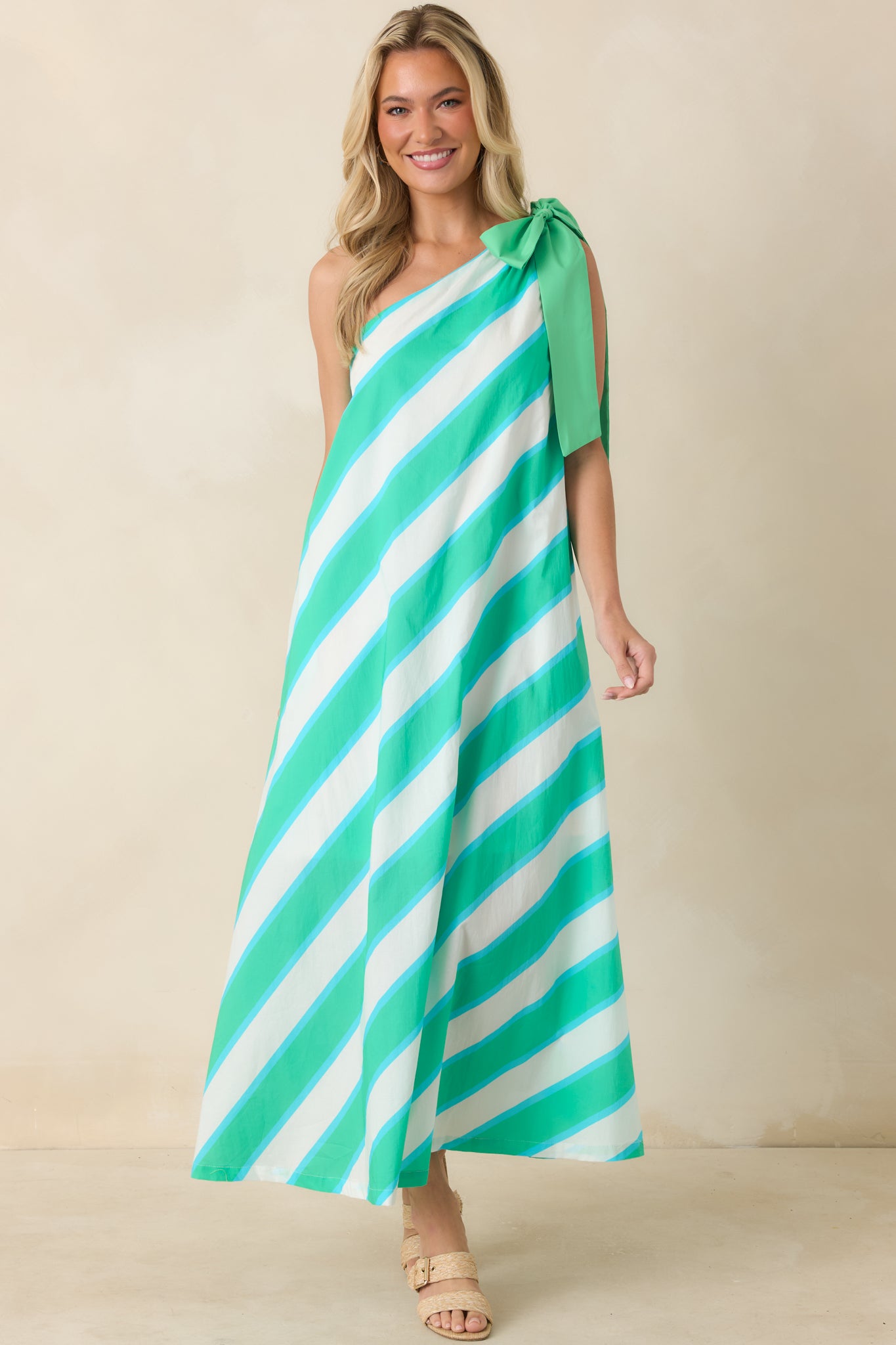 Aqua and mint striped dress with an oversized shoulder bow, fully lined construction, and an airy maxi-length design.