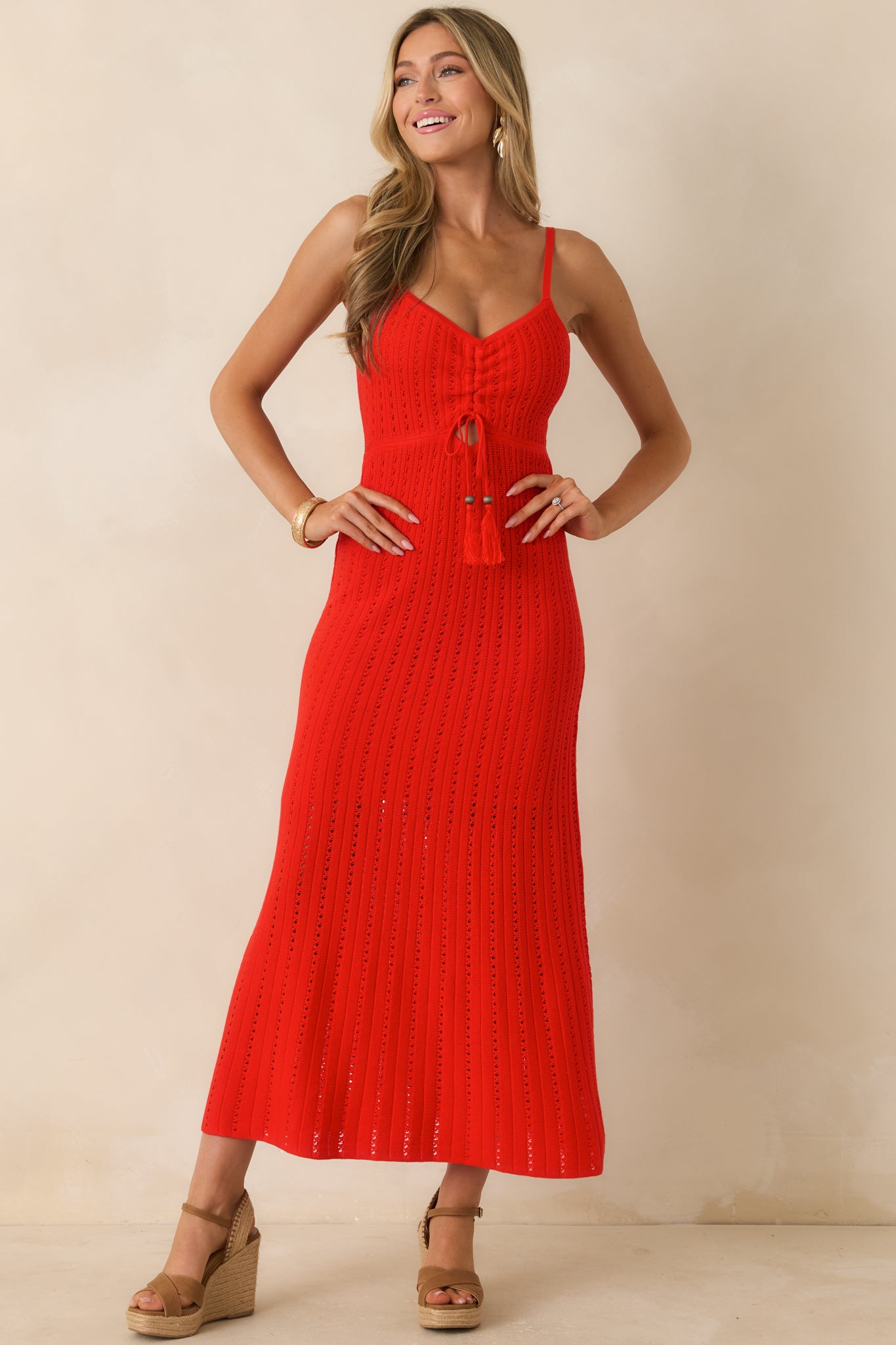Poppy red crochet maxi dress highlighting the intricate open-knit pattern, ruched bodice, and flowing full-length design.
