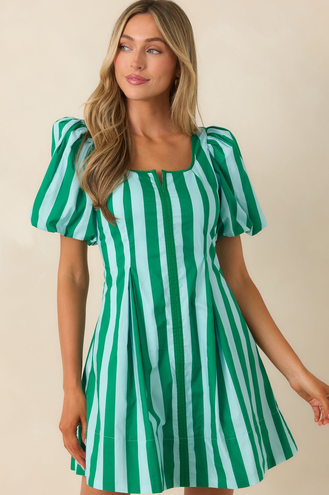 Cropped view emphasizing the softly flared skirt and hidden side pocket placement for functional design.