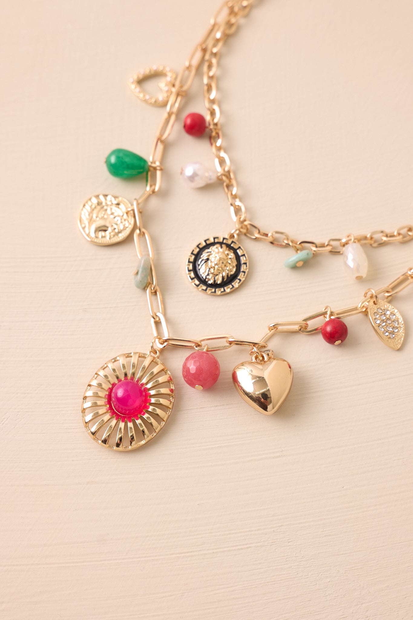 A detailed shot of the assorted gold and multicolor charms, highlighting their unique shapes and vibrant accents.