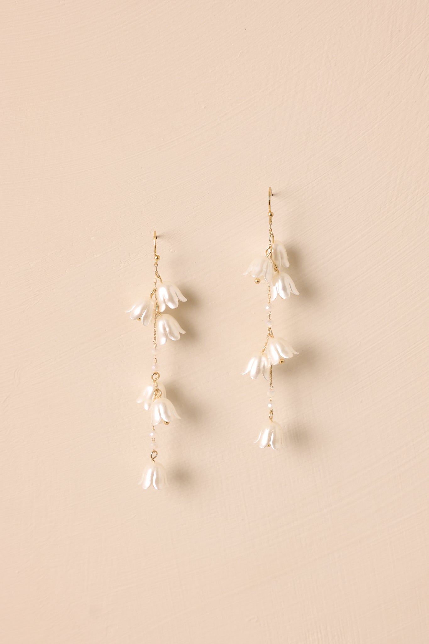 A close-up view of the cascading pearlescent flowers and small ivory beading, highlighting the intricate detailing and soft shimmer.