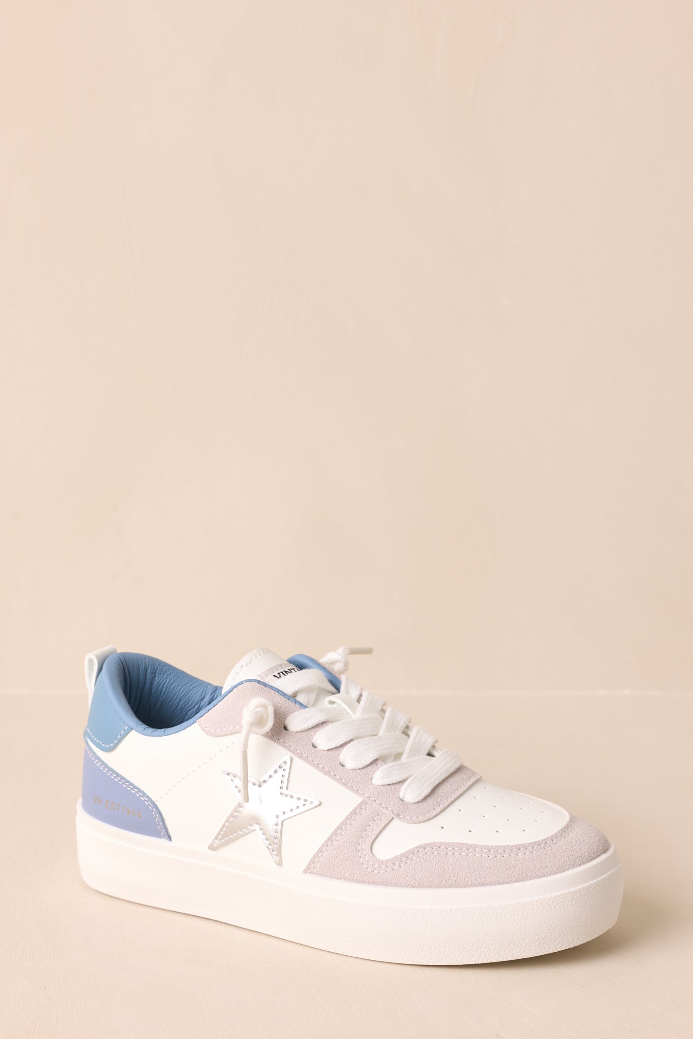 Angled view emphasizing the smooth faux leather and contrasting suede panels.