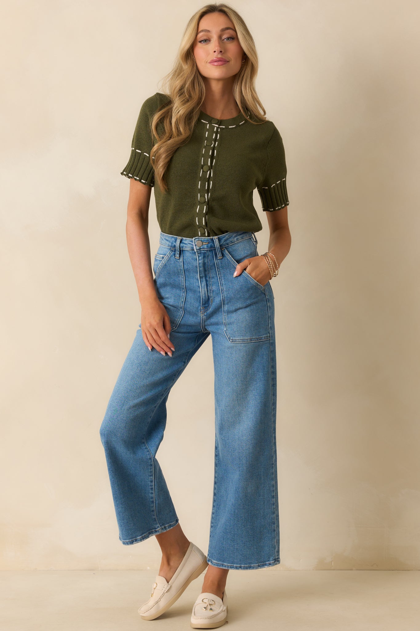 Cardigan featuring functional button front closure and contrast white stitching.