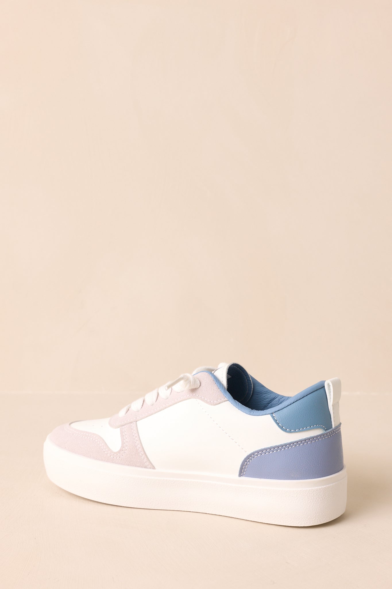 Rear view of blue low-top sneakers showing the chunky sole and heel design.