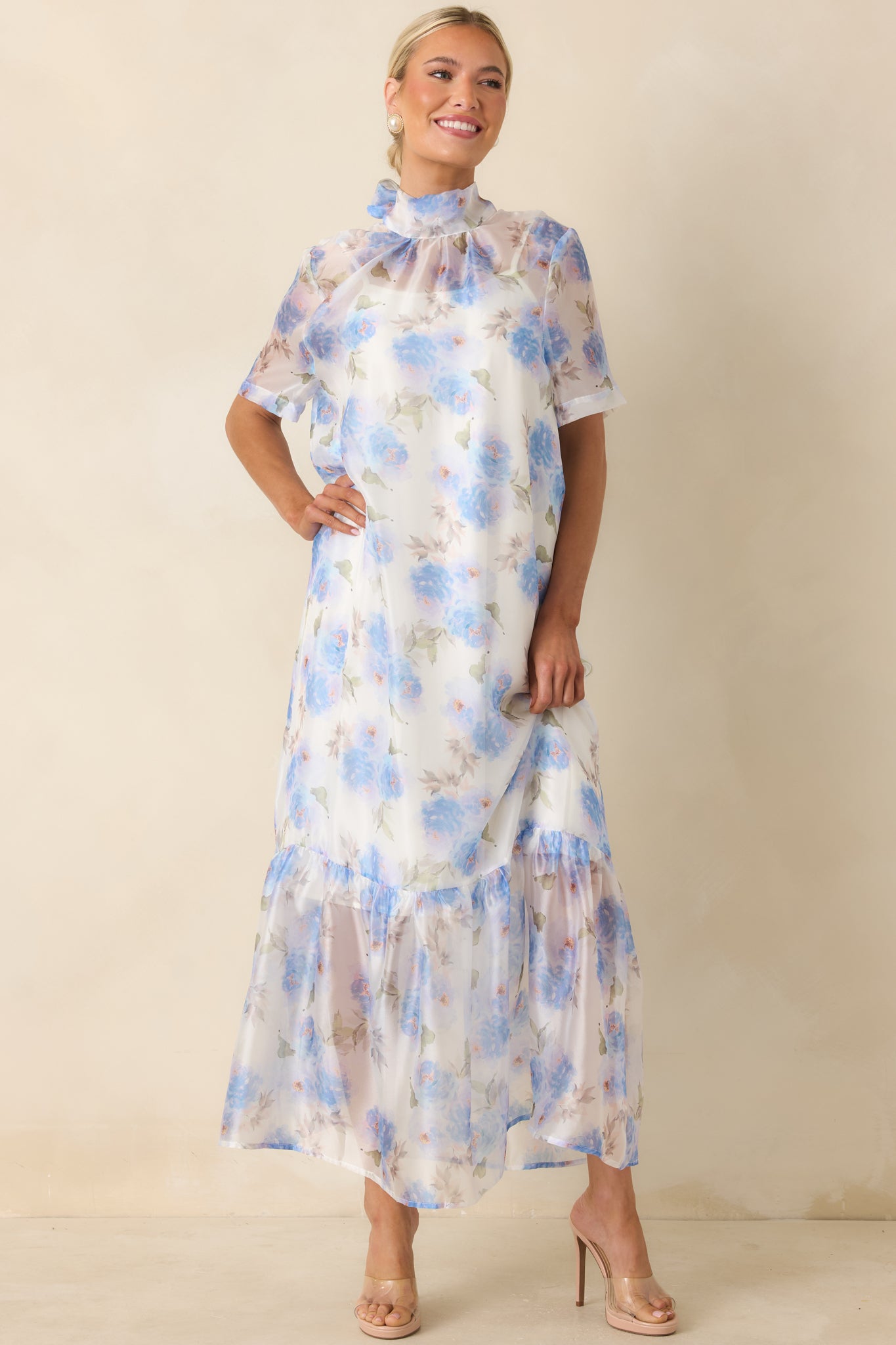 Floral maxi dress showcasing a soft watercolor print, airy sleeves, and an elegant ruffled hemline.