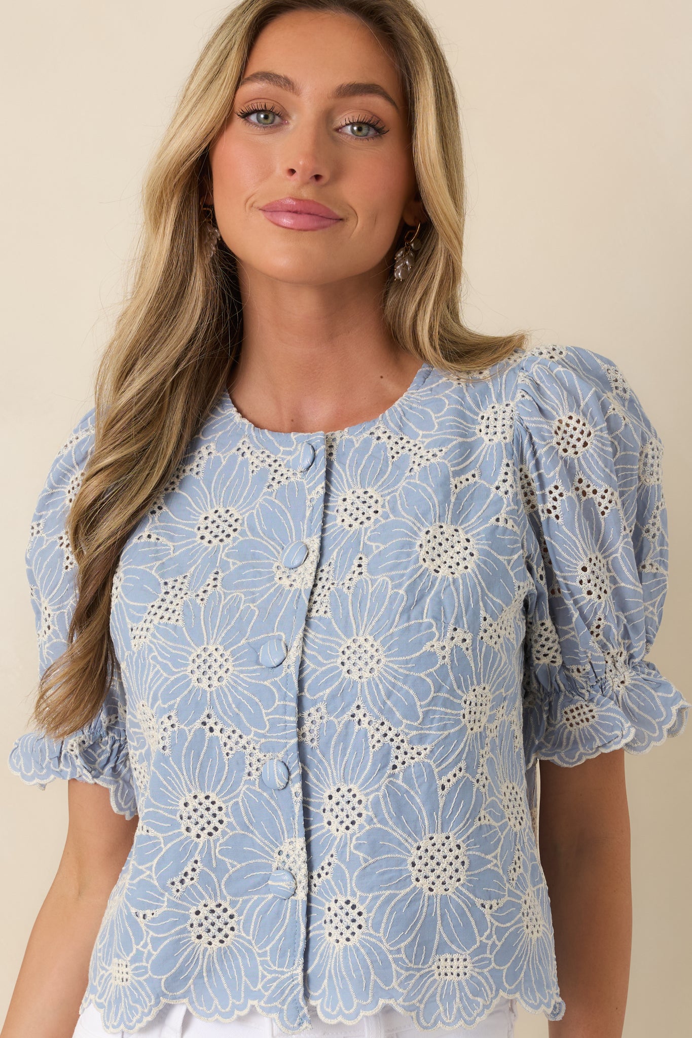 Button-front design with textured eyelet and floral embellishments.